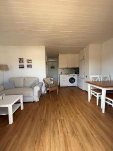 a living room with a couch and a table at Apartamento Cala En Bosch B10 in Cala en Bosc