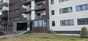 an apartment building with a small tree in front of it at LUAME Residence , langa Arena Mall, aproape de centru in Bacău