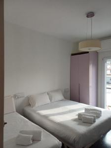 a bedroom with two beds with towels on them at UN BEL POSTO AL MARE in Savona