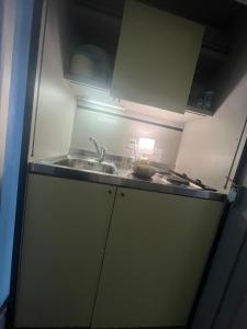 a kitchen with a sink and a counter top at 18 Steps to a Secret Tower in Porrentruy +3 photos