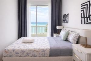 a bedroom with a bed with a view of the ocean at Straits Quay Seafront Suite l Panoramic Seaview in Tanjong Tokong +46 photos