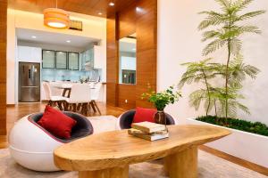a living room with a table and chairs and a dining room at Straits Quay Seafront Suite l Panoramic Seaview in Tanjong Tokong