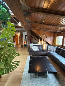 a living room with a couch and a table at BLUELAND Loft in Hechendorf