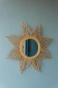 a gold sunburst mirror on a wall at BUKU BUKU by Bara Beach in Galle