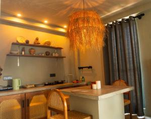 a kitchen with a table with chairs and a ceiling at BUKU BUKU by Bara Beach in Galle