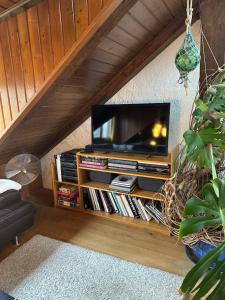 a living room with a flat screen tv on a shelf at BLUELAND Loft in Hechendorf