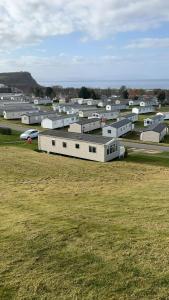 a group of buildings in a field of grass at JSNHolidays at Craig Tara Holiday Park in Ayr