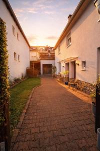 a brick walkway between two white buildings at Ferienwohnung Theisen in Bernkastel-Kues