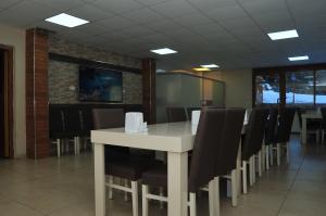 a dining room with a white table and chairs at Çam Otel 2 in Uzungöl