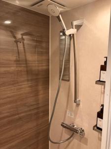a shower in a bathroom with a shower head at ジャンハウス in Takayama +37 photos