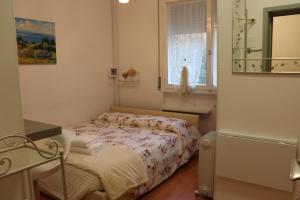 a small bedroom with a bed and a window at Monika Holiday 302 Joy in the lake in Garda +112 photos