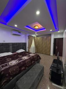 a bedroom with a bed and a blue ceiling at 3 Bedroom Flat Short Let in Iseri
