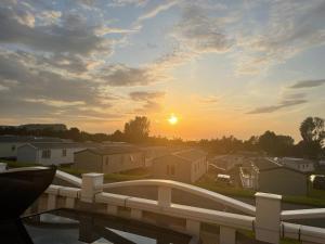 a view of the sunset from a balcony at JSNHolidays at Craig Tara Holiday Park in Ayr