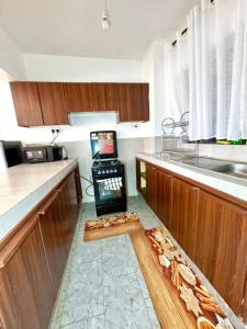 a kitchen with a counter with a laptop on it at brigit's home in Kisumu