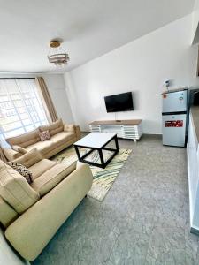 a living room with a couch and a table at brigit's home in Kisumu