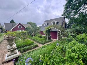 a garden in front of a red house at Drewry Lane in Howick