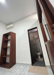 a bathroom with a toilet and a mirror at Apartamento Barbosa in Santarém