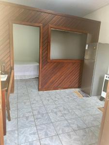 a kitchen with a refrigerator and a tile floor at Apartamento Barbosa in Santarém