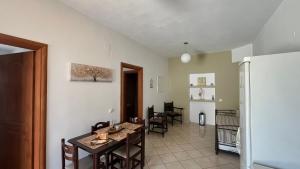 a kitchen and dining room with a table and chairs at Magic estate on the wave 2 by Villa Lagkadaki in Kotronas