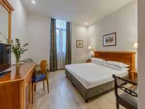 a hotel room with a bed and a desk and a computer at Hotel Diplomatic in Rome +62 photos