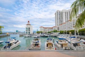 a group of boats docked in a marina with buildings at Straits Quay Seafront Suite l Panoramic Seaview in Tanjong Tokong