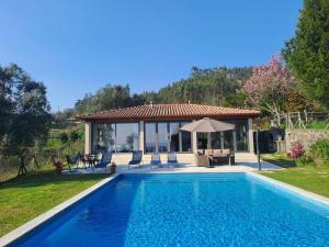 a villa with a swimming pool and a gazebo at The Pool House in Longos
