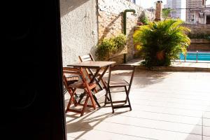 a table and chairs sitting on a patio at Pousada Aconchego Manaíra in João Pessoa