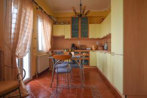 a kitchen with a table and some chairs in it at Evaggelia's Seaside Boutique Apartment in Ireon