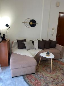 a living room with a couch and a table at Castle Town Apartment in Dhidhimótikhon
