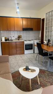 a kitchen with a couch and a table in a room at Castle Town Apartment in Dhidhimótikhon
