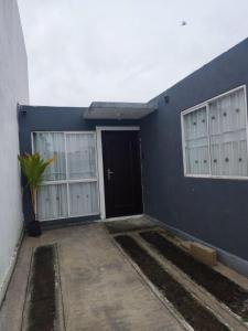 a blue building with a door and a plant next to it at Casa completa en Puente Moreno Ver in Playa de Vacas