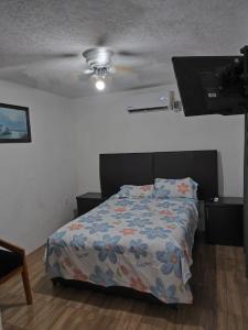 a bedroom with a bed and a ceiling fan at Casa completa en Puente Moreno Ver in Playa de Vacas