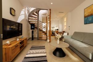 a living room with a couch and a table at Evmaria Luxury Cottage in Agios Myronas