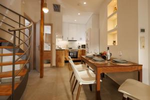 a kitchen and dining room with a table and chairs at Evmaria Luxury Cottage in Agios Myronas