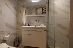 a bathroom with a sink and a shower at Evmaria Luxury Cottage in Agios Myronas +31 photos