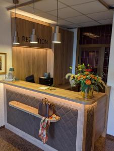 a reception desk in an office with a purse at Zenners Landhotel in Newel