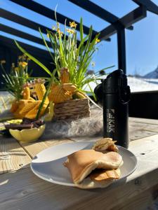 a plate of food sitting on a wooden table at Cabin with sea view in Moen +42 photos