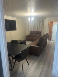 a living room with a couch and a table at Godwinning lodge in Thamesmead
