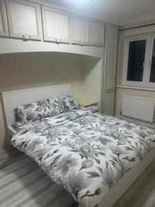 a bedroom with a bed with a white comforter at Godwinning lodge in Thamesmead +7 photos
