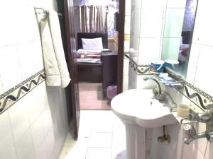 a bathroom with a sink and a mirror at Hotel The Shalimar in Lahore +59 photos