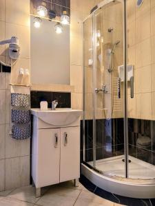 a bathroom with a sink and a shower at Apartamenty WIKTORIA morska18 in Kuźnica +52 photos