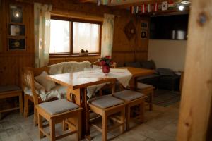 a living room with a table and chairs and a couch at Privat Luna in ľubeľa