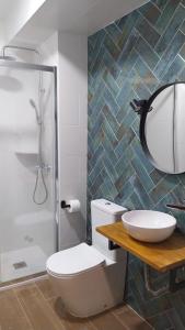 a bathroom with a toilet and a sink and a shower at Hostal Andalucía in Chipiona