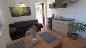 a living room with a couch and a table at Agroturystyka Serce Łysicy in Święta Katarzyna