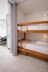 two bunk beds in a room with a window at centre port le cocon 4 couchages in Cap d'Agde