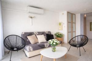 a living room with a couch and two chairs at centre port le cocon 4 couchages in Cap d'Agde