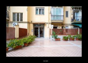 a building with potted plants in front of it at Casa Porta D'Amalfi vicino Stazione e terminal Sita Salerno in Salerno