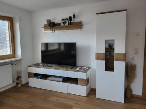 a living room with a flat screen tv on a wall at Ferienwohnung Pöll in Stanz bei Landeck