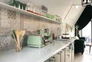 a kitchen with a green appliance on a counter at Acasa Straja - Green Cottage in Lupeni