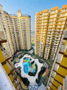 an aerial view of a park in the middle of buildings at AM Living in Ghaziabad